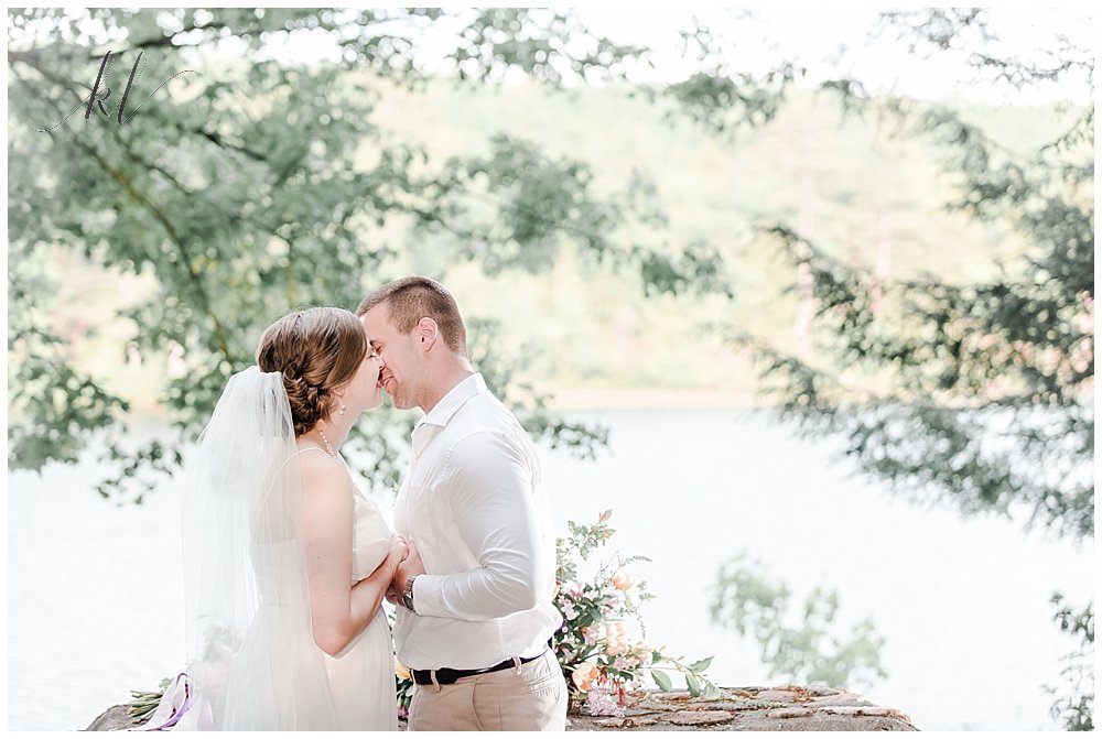 Bride and Groom share a first kiss during their wedding ceremony at Camp Takodah in Rindge NH