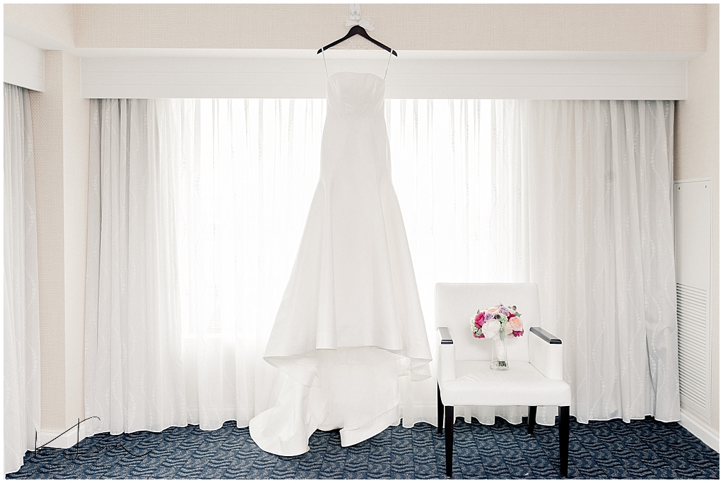 Wedding Dress hanging in window. 