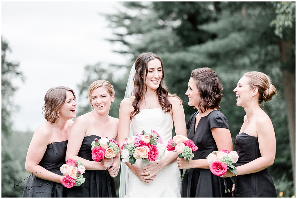 Photo of Bridesmaids wearing black dresses with Brightly colored floral bouquets taken at a Bradley Estate Wedding