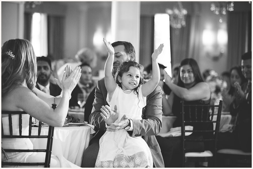 Young girl clapping after a speech was given at the Equinox Wedding Reception. 