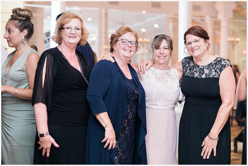 Four women, friends since childhood, pose for a photo during a wedding reception at the Equinox. 