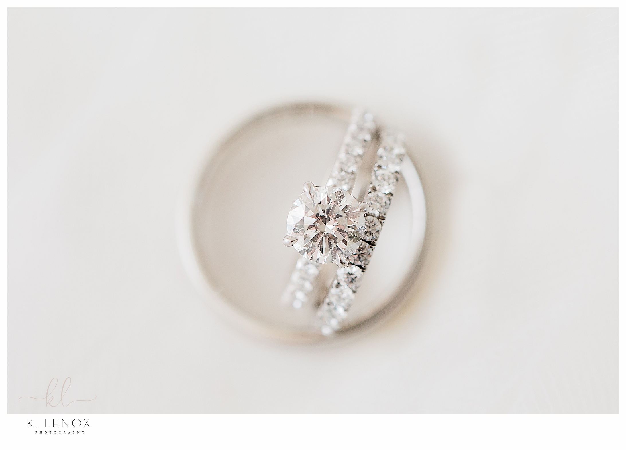 Clean and Simple ring shot showing a diamond engagement ring and an eternity wedding band. 