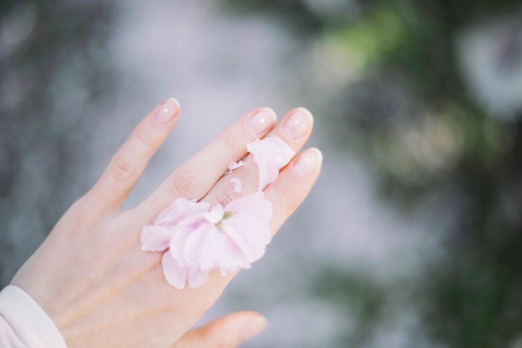 Best Beauty Tips and Trick For Your Wedding Day- Photo of Hand and flower petals. 