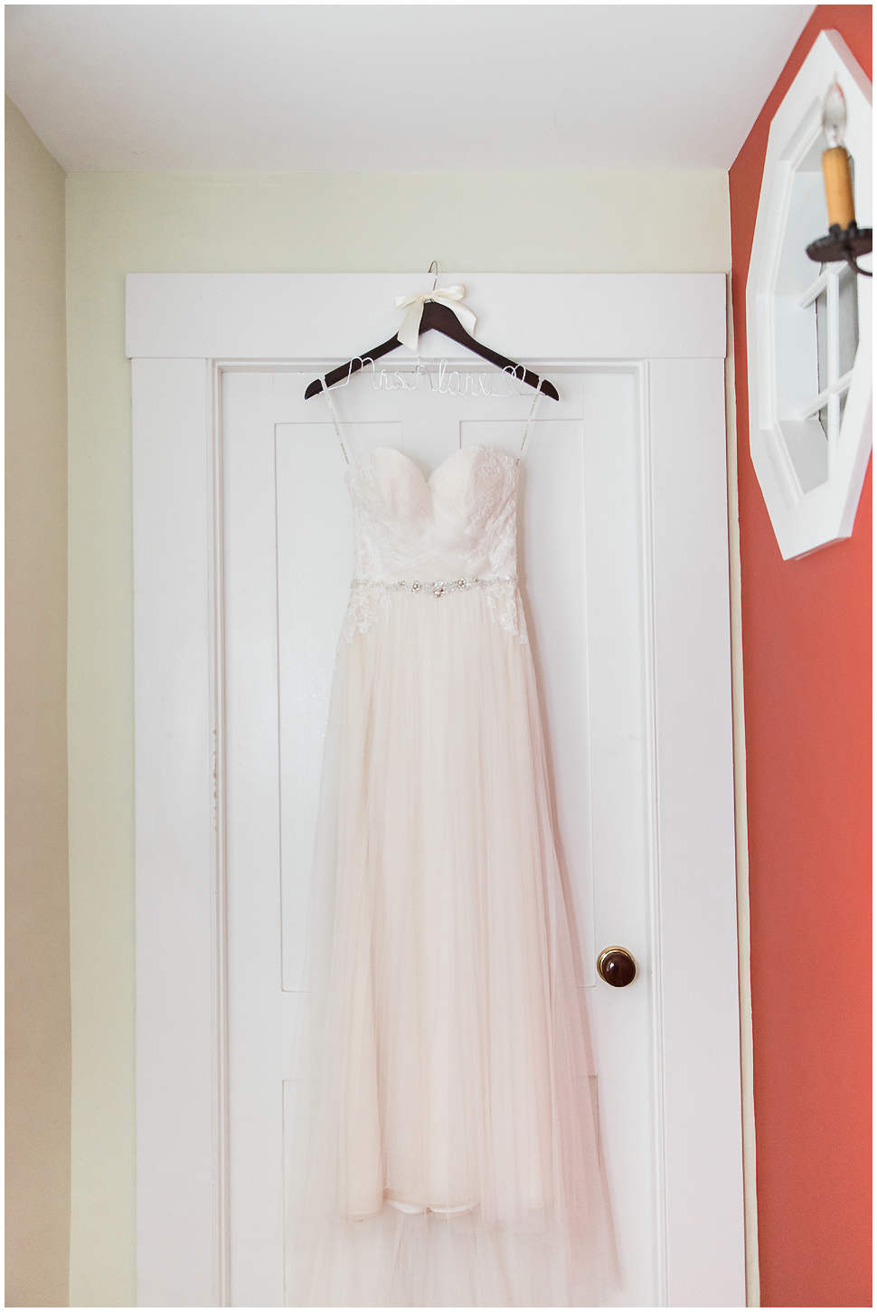Alyson's Orchard Wedding- Wedding Dress hanging on a white door. 