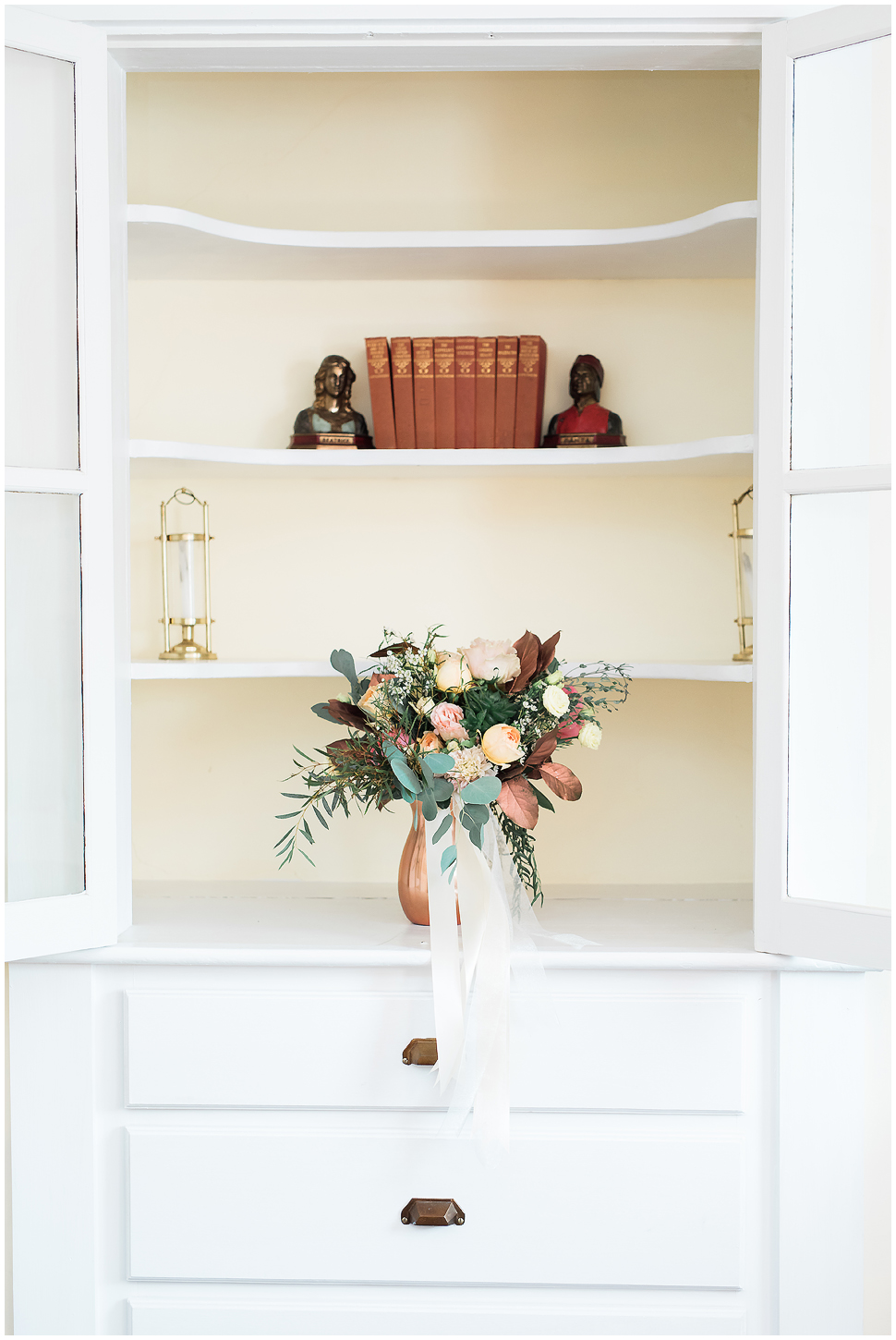 Bridal bouquet in a copper vase pictured in a built in shelf at Alyson's orchard. 