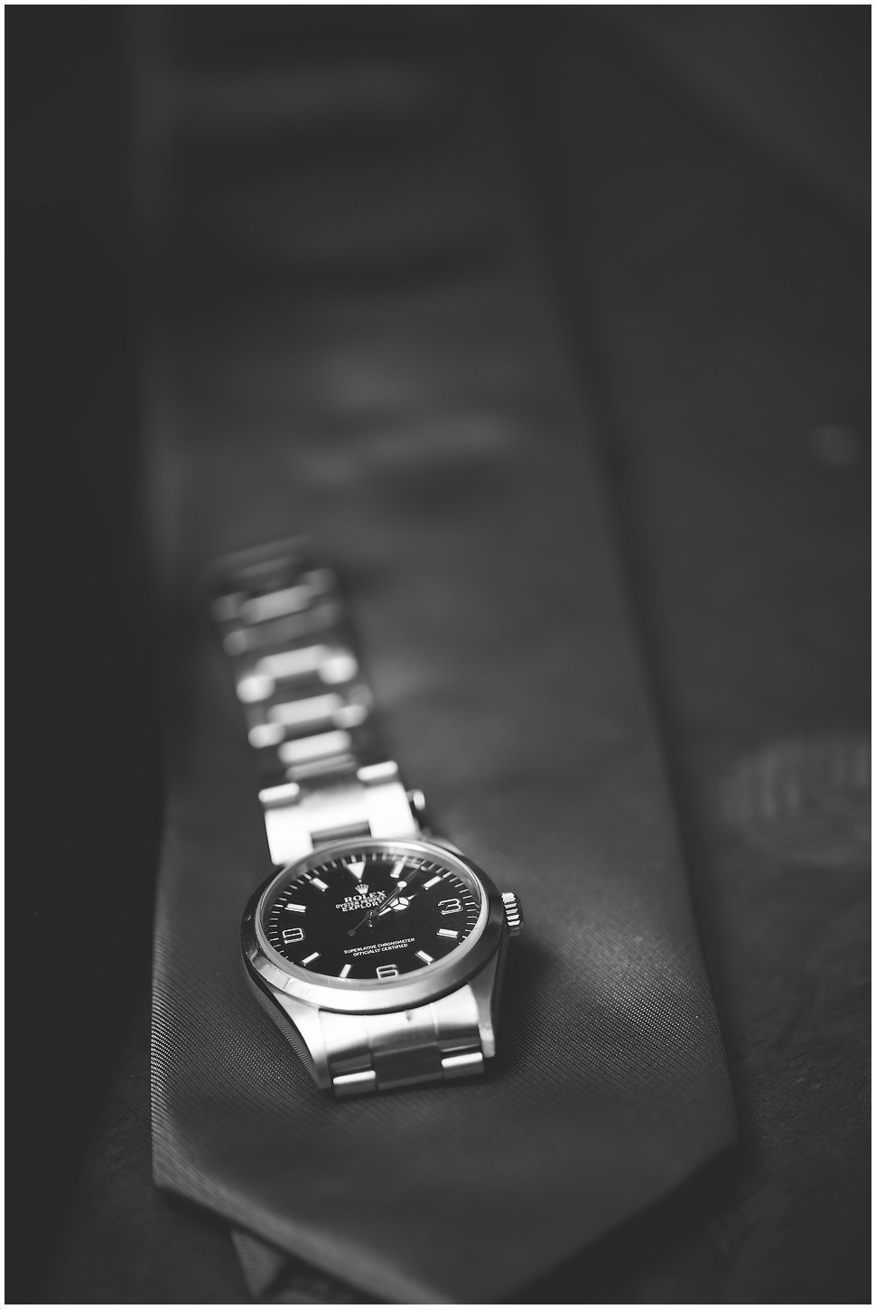 Rolex Watch and a tie. Black and white photo. 