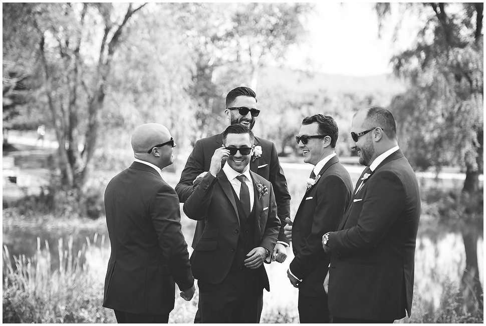Black and white groomsmen candid portrait at Alysons orchard. 