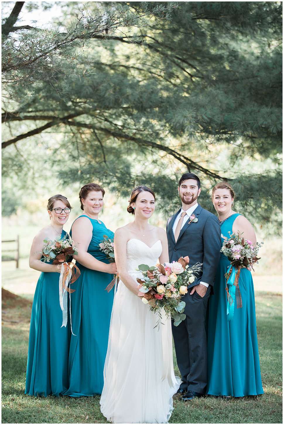 Formal Wedding portrait of bride and bridesmaids wearing teal dresses. Brother of bride in Grey suit. 