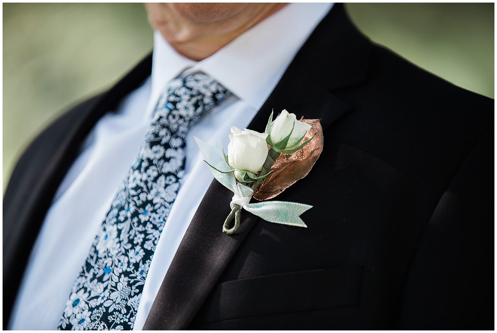 Mens Boutonnière with two small white roses and a copper leaf. Made by Naturally Elegant Designs. 