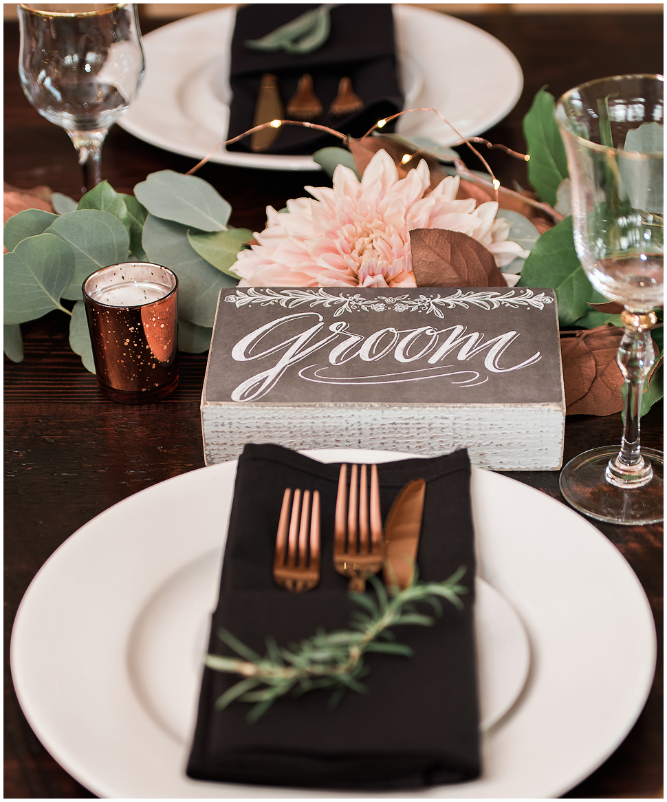 Grooms table area at wedding reception showing copper forks and knife. 