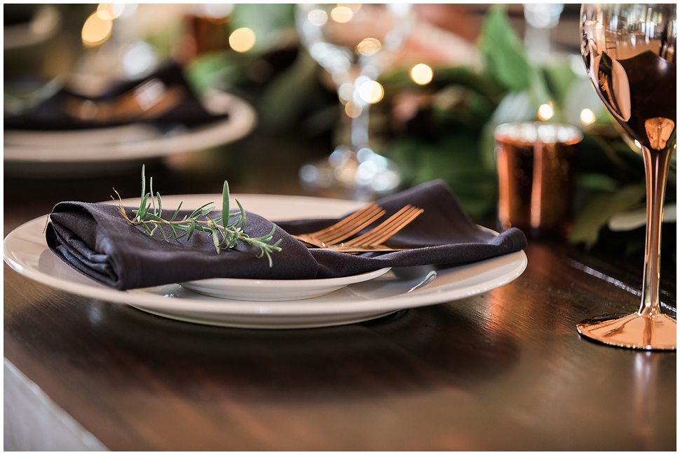 Copper forks, black napkin detail photo at wedding reception