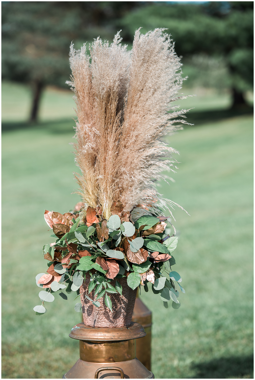 Wheat Grass and Copper leaves on a copper tin. Wedding ceremony decor at Alyson's Orchard. 