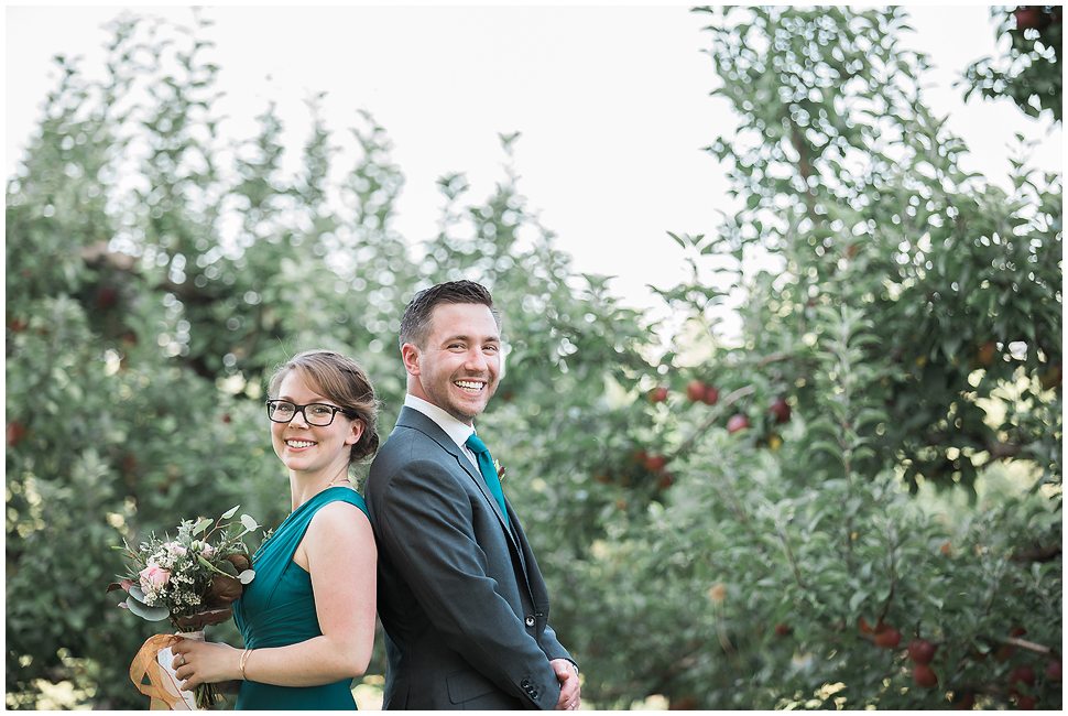 Groom and his sister pose for a silly portrait in the Orchard at Alyson's. 