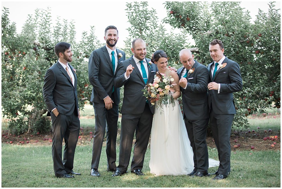 Candid and unposed portrait of the bride and groomsmen at Alyson's Orchard. 