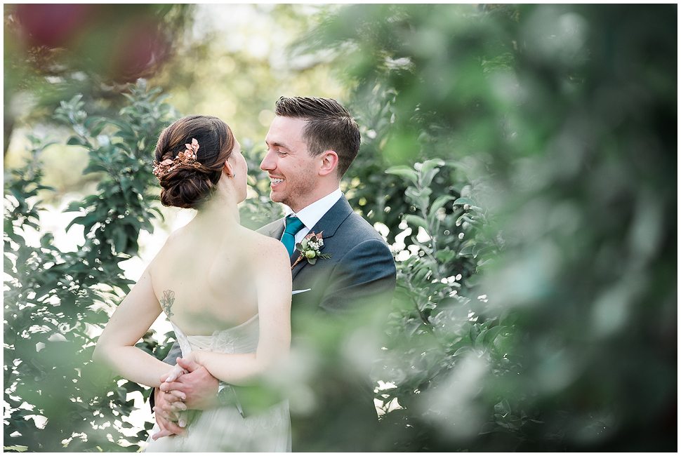 Bride with Copper hairpiece with her husband At Alyson's Orchard. 
