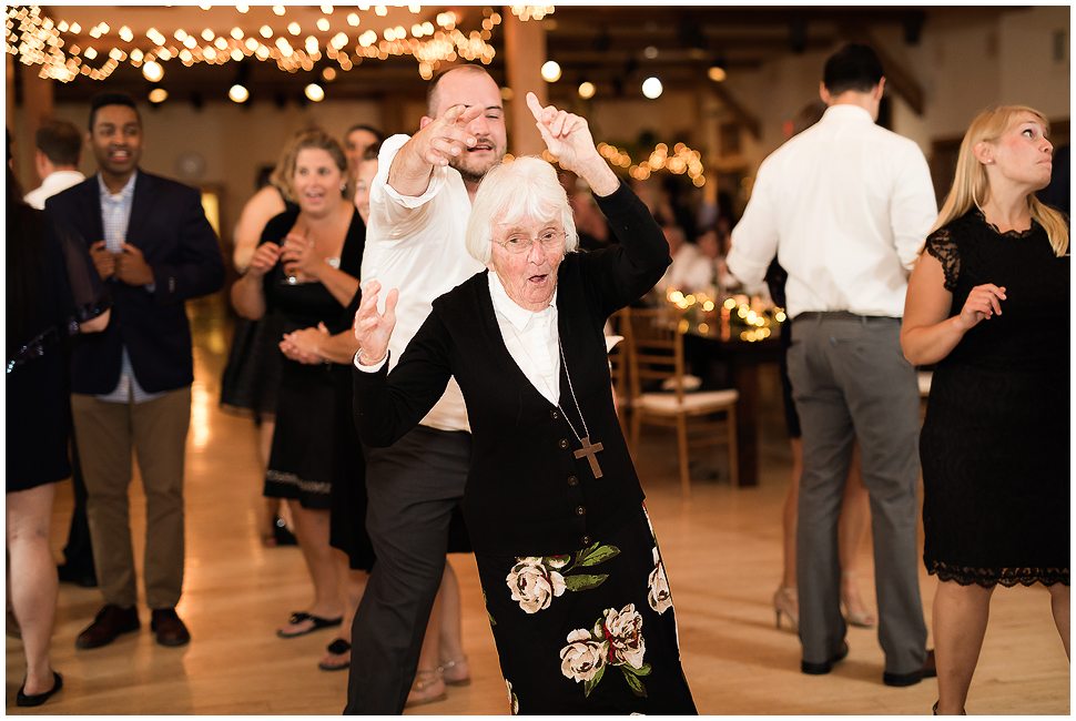 Groomsman twirls 96 year old woman at wedding reception. 