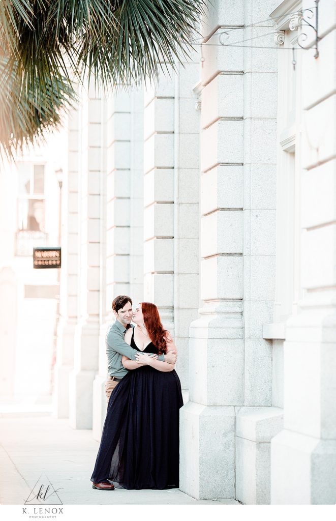 Light and Airy Photo of a man and woman kissing during their engagement session in Charleston SC with K. Lenox Photography