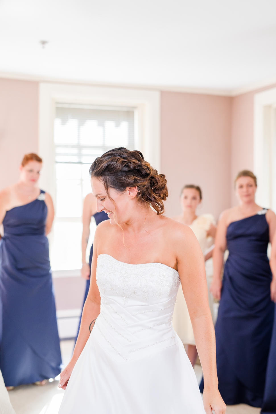 bride helped in to her dress from David's Bridal before the wedding ceremony