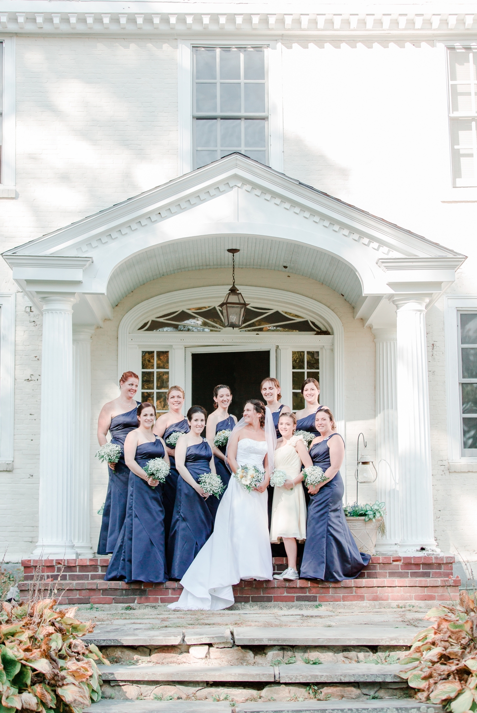 bride with bridesmaids on the entrance stairs at the Grand View Inn Resort Wedding Jaffrey NH
