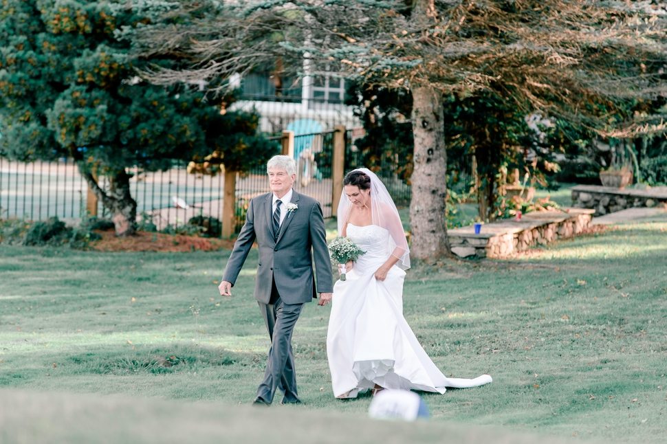 bride walks to the wedding ceremony with her dad at her Grand View Inn Resort Wedding 