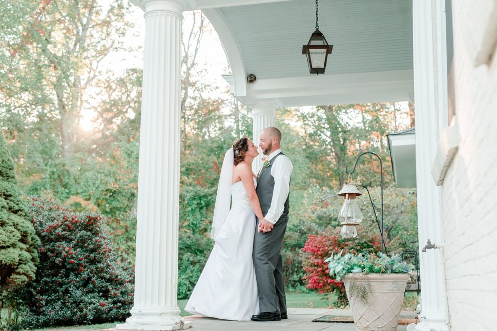 bride and groom have a moment together at the entrance to Grand View Inn Resort at sunset in the fall