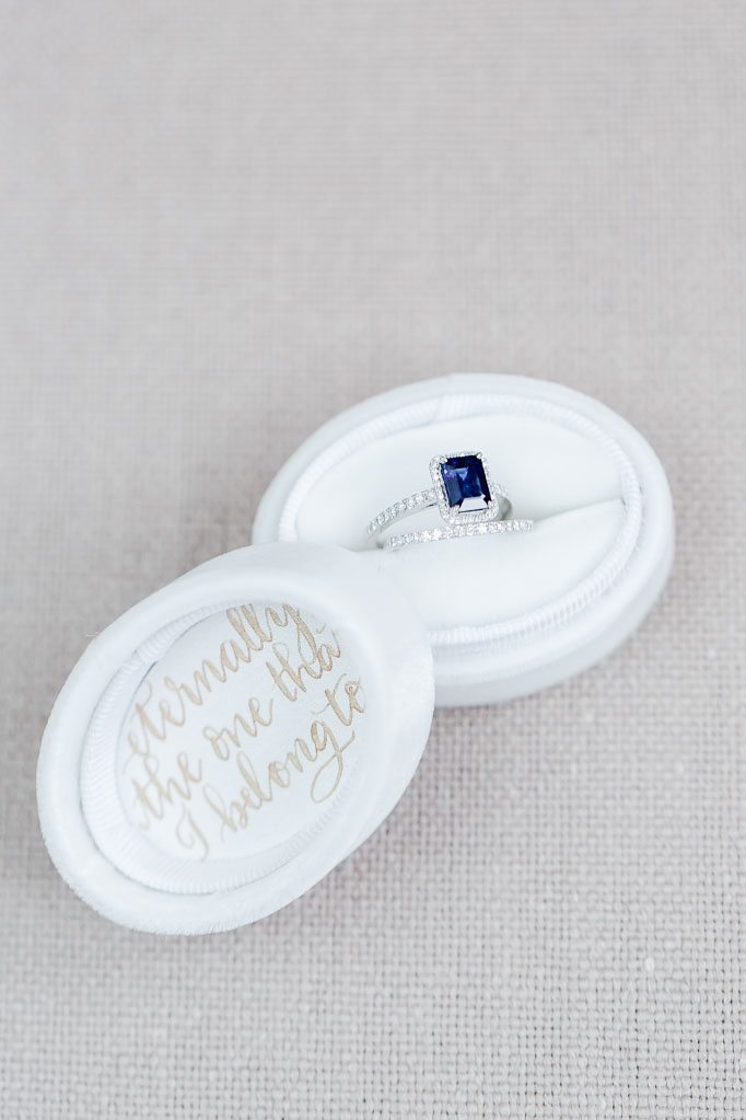 Blue Saphire Engagement Ring with white gold wedding band in a white velvet box. 
