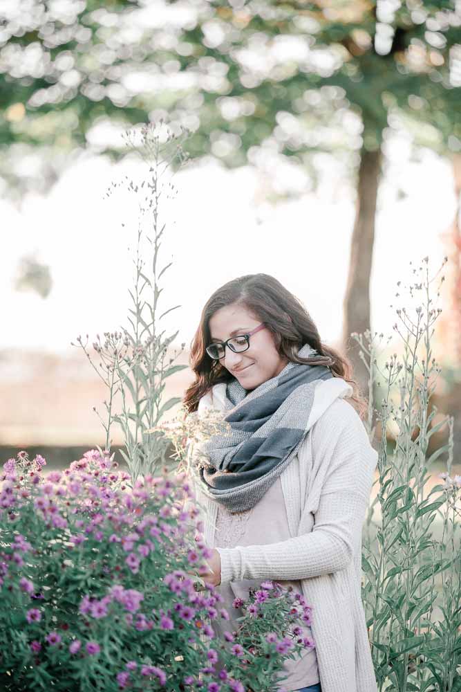 Monadnock High School senior girl looking at purple flowers. Light and Airy photography. 