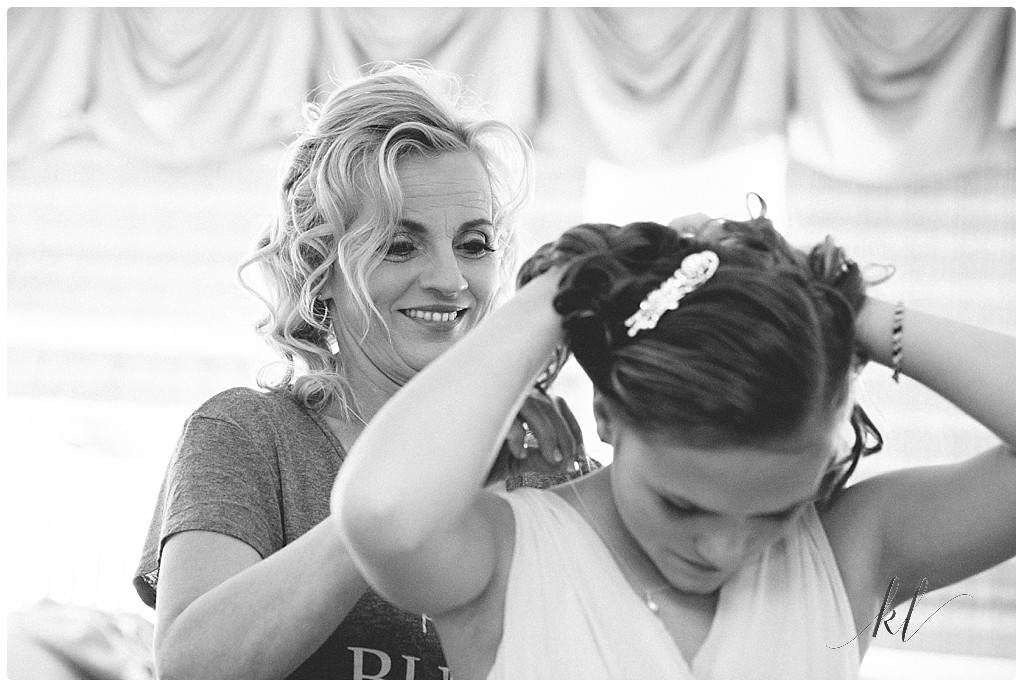 Black and white image of mom putting on daughters necklace in preparation for her Wedding at Riverside Hotel NH. 
