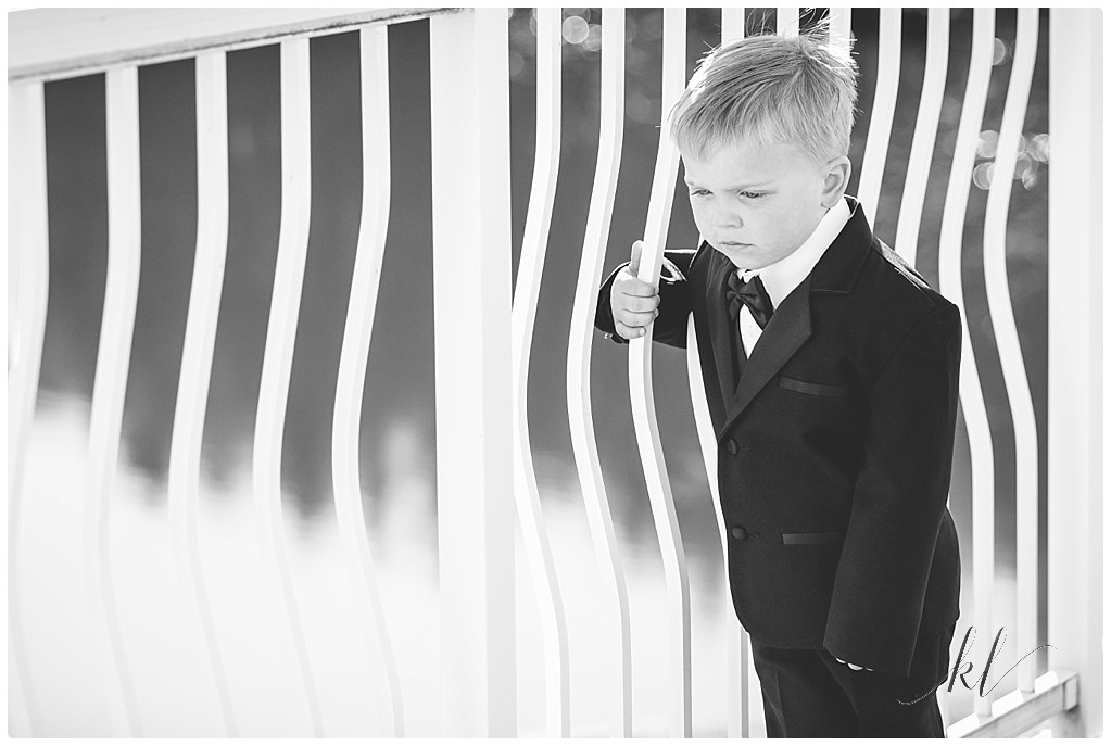 Black and White photo of toddler boy wearing a tux. 