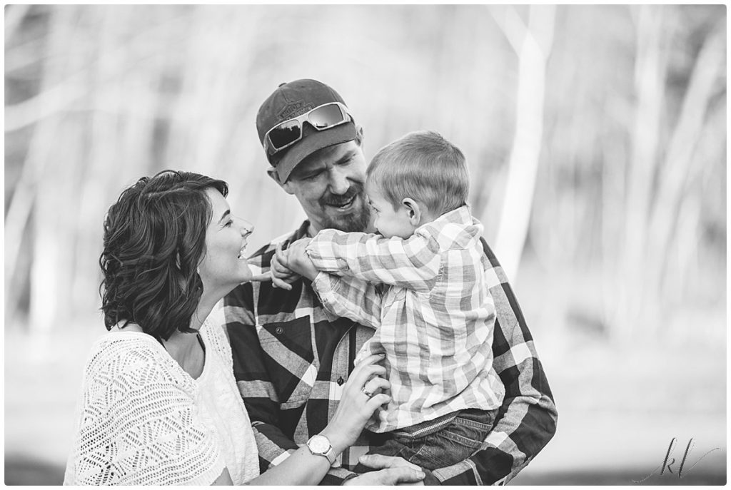  Black and White Candid photo of a family of three while getting some fun family photos