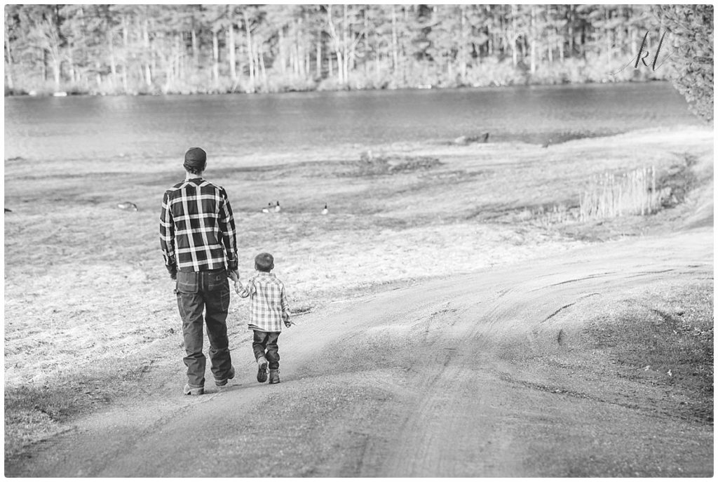 Fun Family Photos- Black and White photo of Father and Son walking holding hands. 