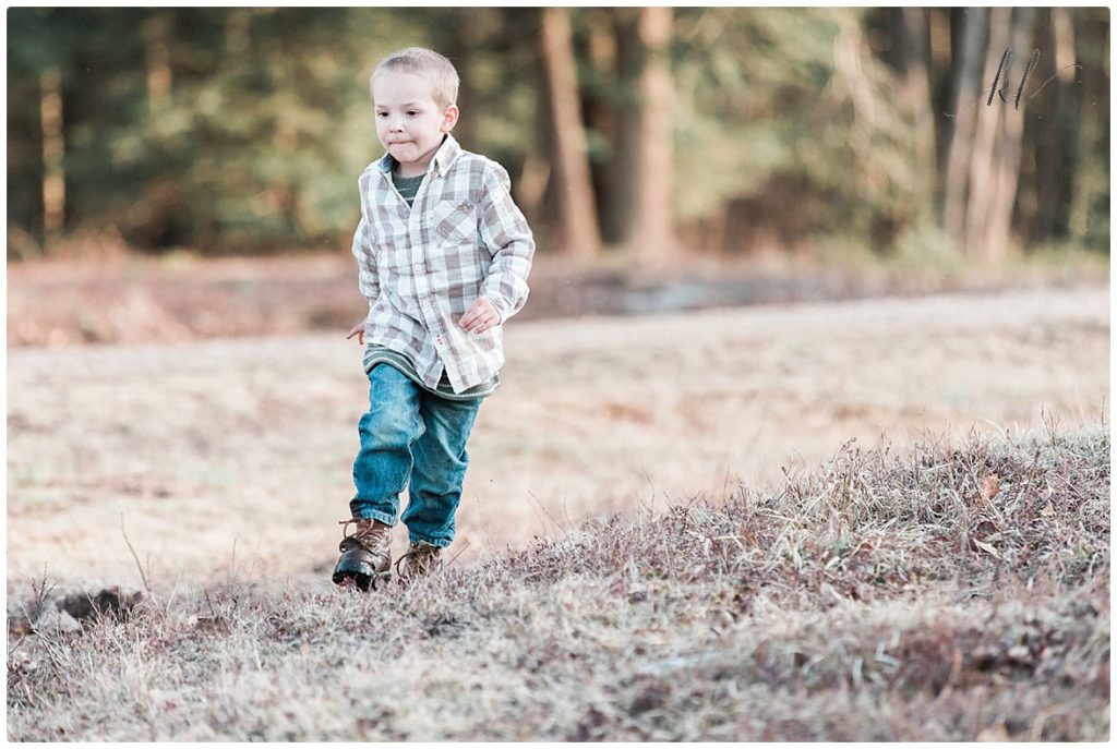 Little boy running and having fun during his fun family photo shoot. 