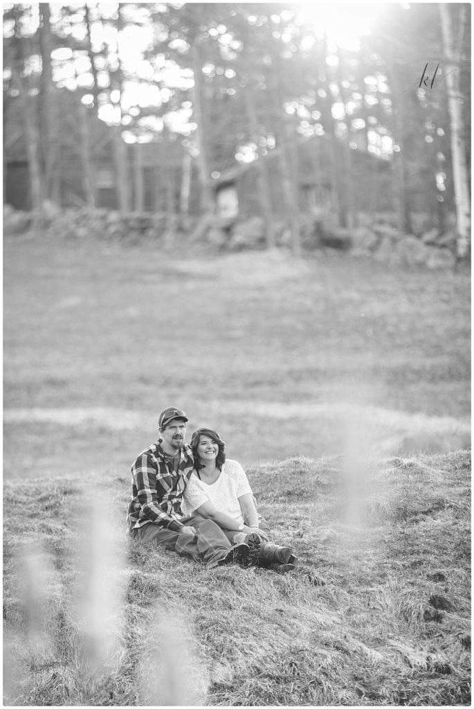 Fun Family Photos- Black and White image of man and woman sitting on a hill. 