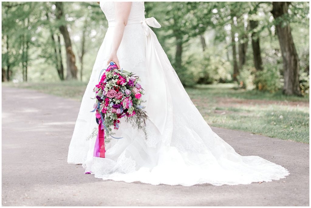 Bright and Airy photo of Big bride's bouquet of pink flowers, purple flowers and greenery. 
