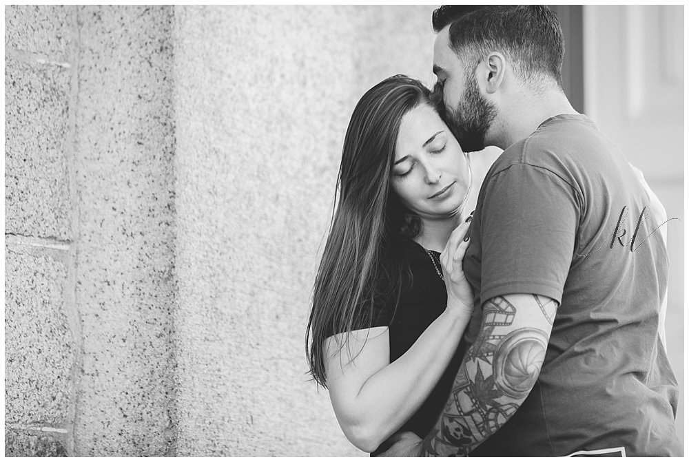 Unposed and Natural engagement photo of man and woman embracing. Black and White 