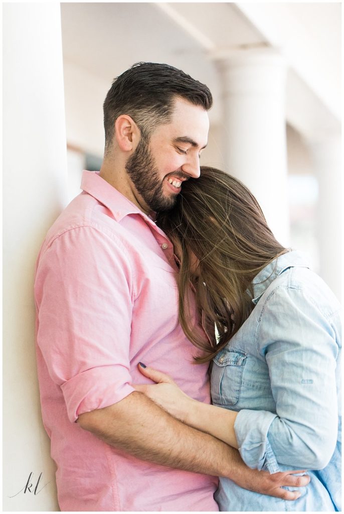 Unposed and Natural Engagement Photo of man and woman hugging. 