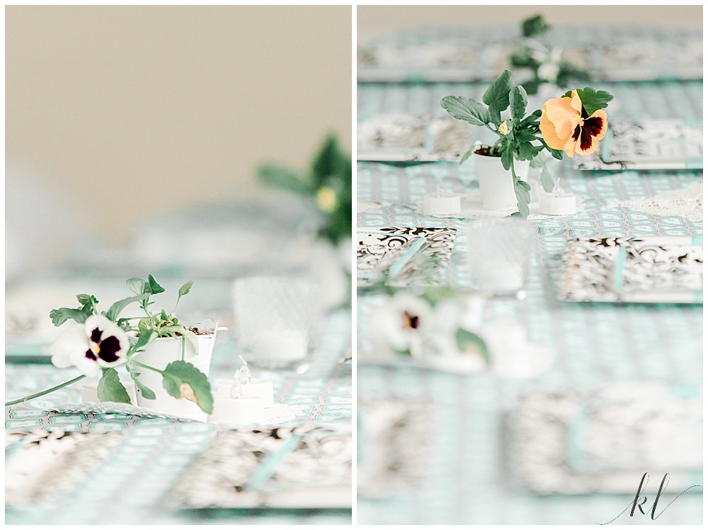 Simple decor for a vow renewal celebration in NH. Teal table cloth with small simple floral piece. 