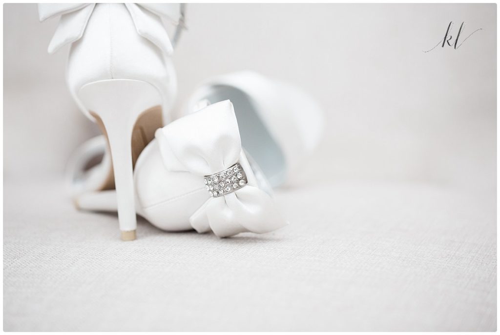 Wedding shoes with jeweled bow on heel. 