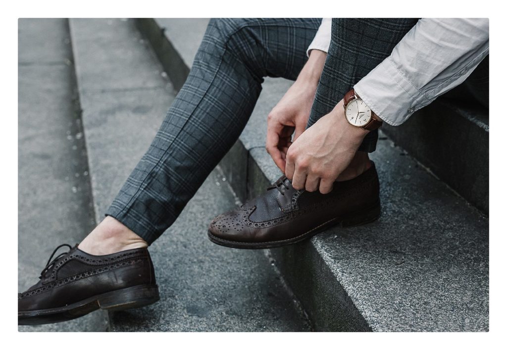 Groom tying his shoes showing a luxury Ambassador Watch. Fashion Tips for the Clueless Groom