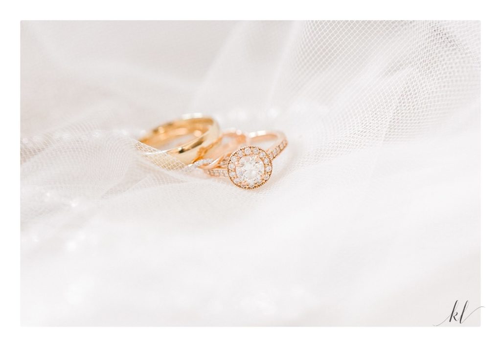 Yellow gold wedding rings with diamond engagement ring detail shot.  Light and airy photo by K. Lenox photography