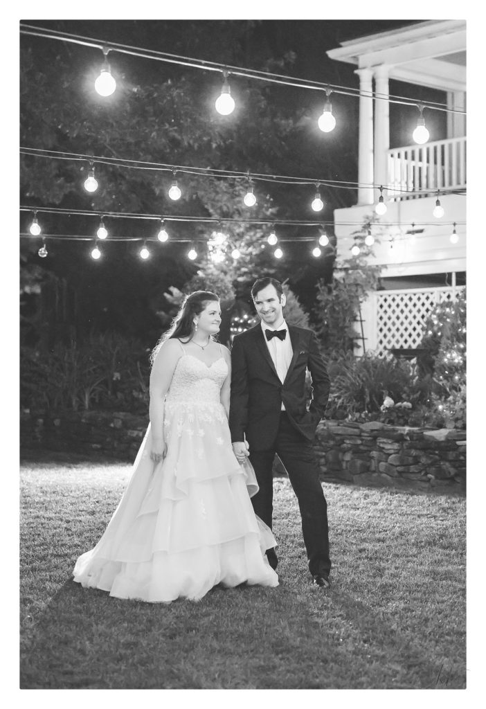 Black and white portrait of a bride and groom at night in the courtyard at the Bedford Village Inn.  Photo by K. Lenox Photography. 