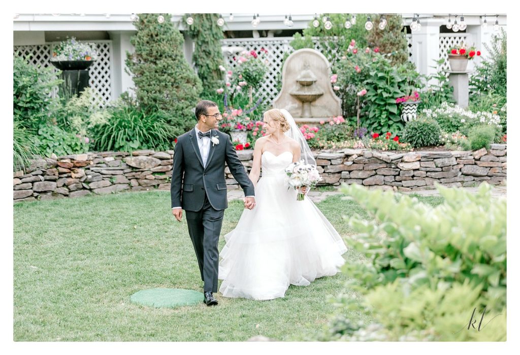 Whimsical Wedding at the BVI- Bride and groom walking in the gardens. 