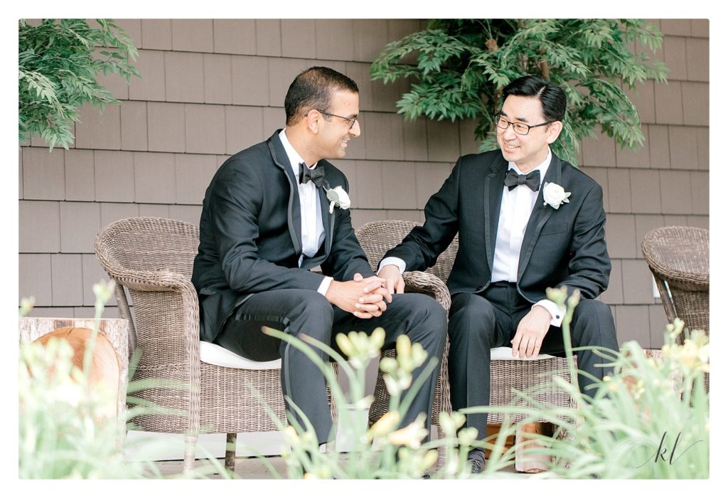 Groom and his best man sitting on the porch of the Bedford Village Inn Grand Hotel. 