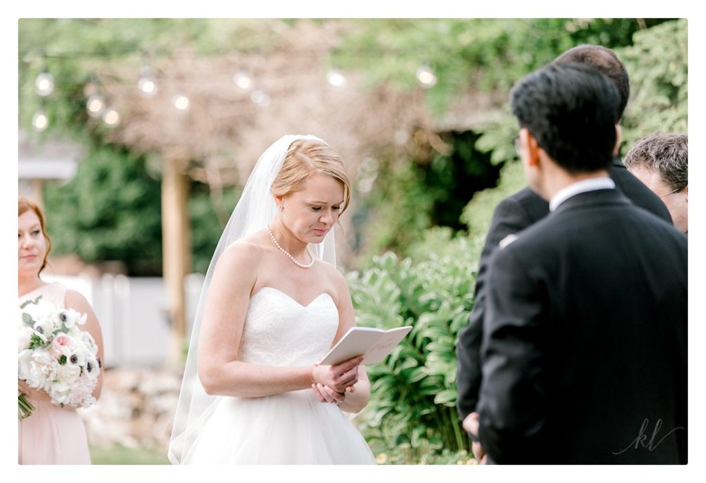 Bride reads her vows during her wedding ceremony at the bedford Village Inn. 