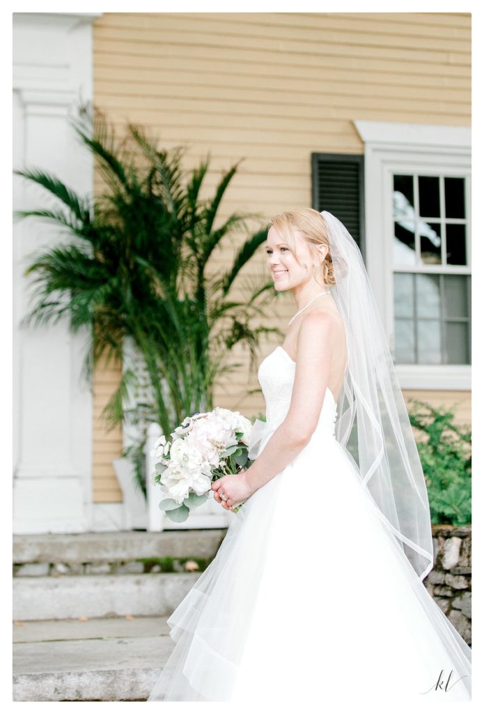 Bridal portrait of a bride wearing a gown by Blush by Hayley Paige. 