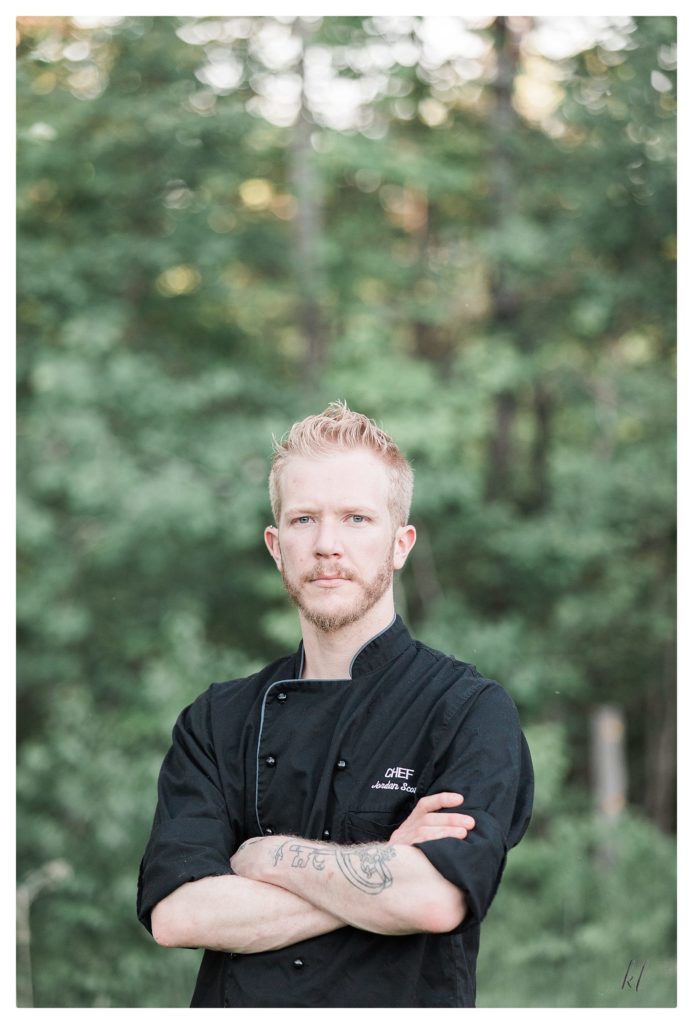 Portrait of Chef Jordan Scott. Chef wearing black coat. Located in Keene NH. 