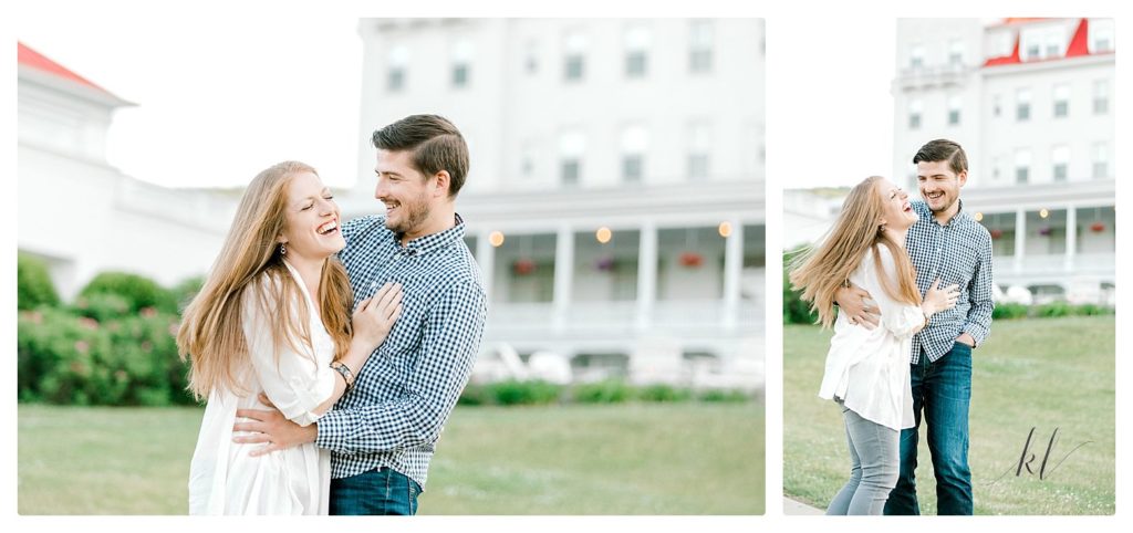 Man and woman laughing behind the Omni Mount Washington Resort during their engagement session. 