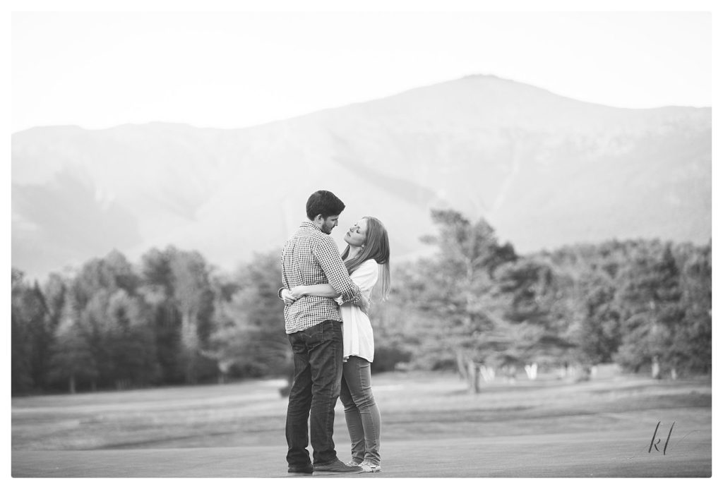 Black and White photo of Man and Woman share a private moment on the grounds of the Omni Mount Washington Resort. 