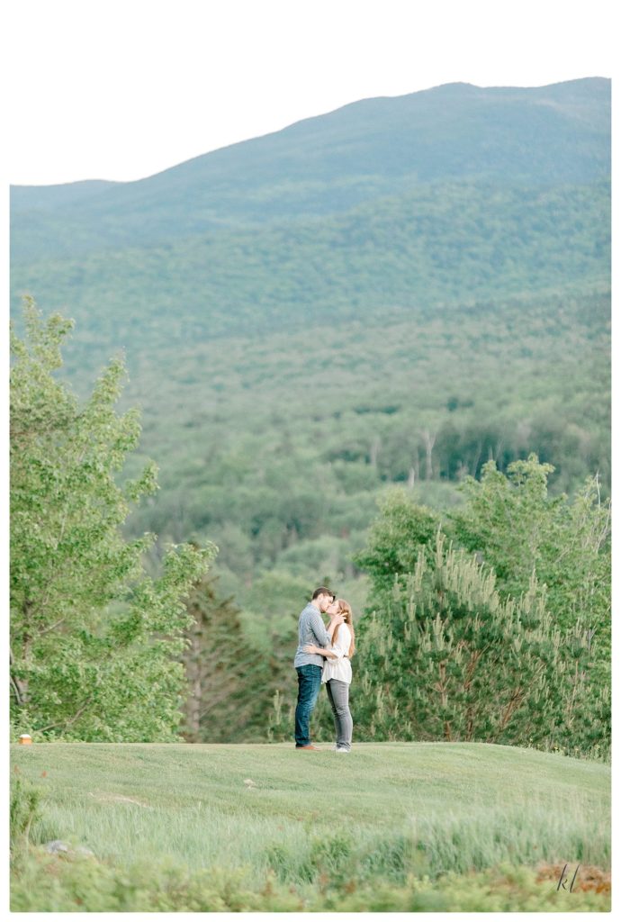 Candid engagement photo taken of a man and woman kissing during their engagement session! 