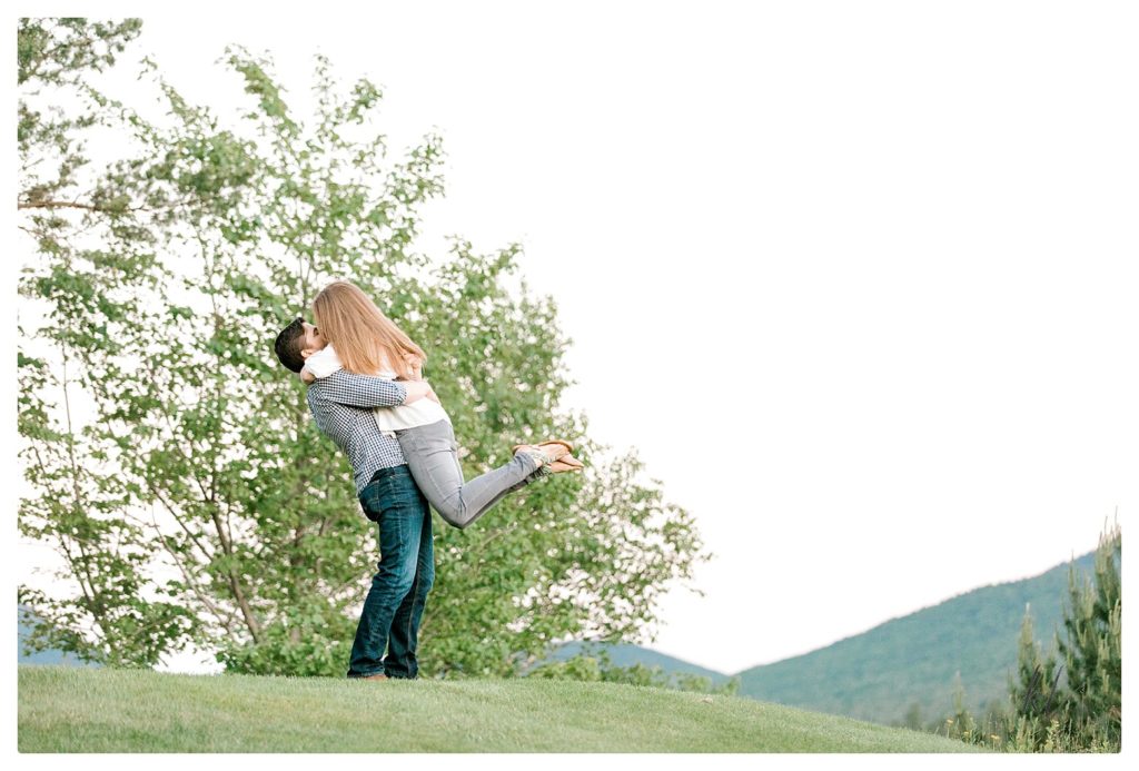 Man picks up his fiance during their Mount Washington Engagement Session